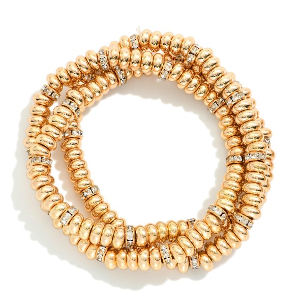 Set Of Three Metal Tone Disk Bead Stretch Bracelets Featuring Rhinestone Details 

- Approximately 2.5" D 

