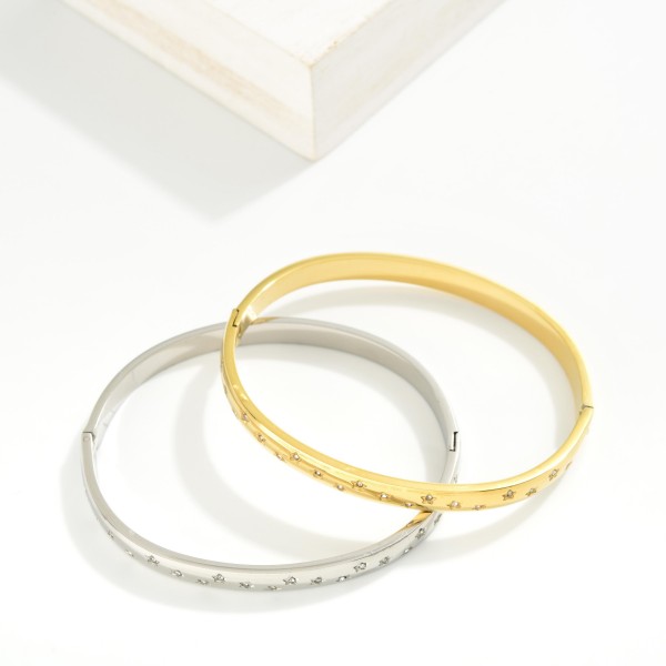 Metal Tone Hinged Bangle Bracelet Featuring Rhinestones & Engraved Star Details 

- Stainless Steel
- Water Resistant
- Approximately 2.5" D