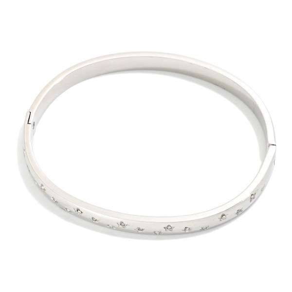 Metal Tone Hinged Bangle Bracelet Featuring Rhinestones & Engraved Star Details 

- Stainless Steel
- Water Resistant
- Approximately 2.5" D