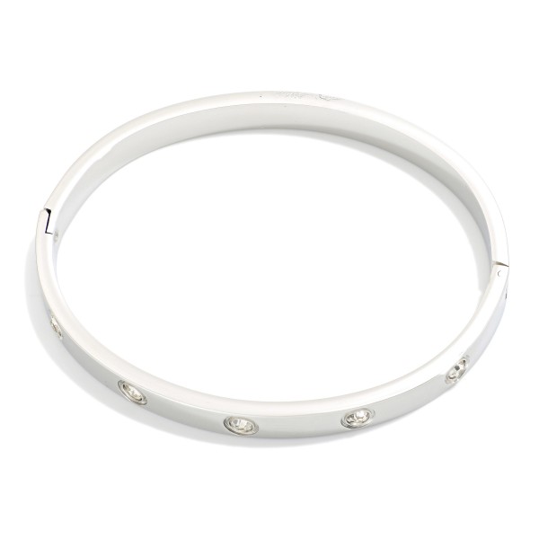 Metal Tone Hinged Bangle Bracelet Featuring Rhinestone Details 

- Stainless Steel
- Water Resistant
- Approximately 2.5" D