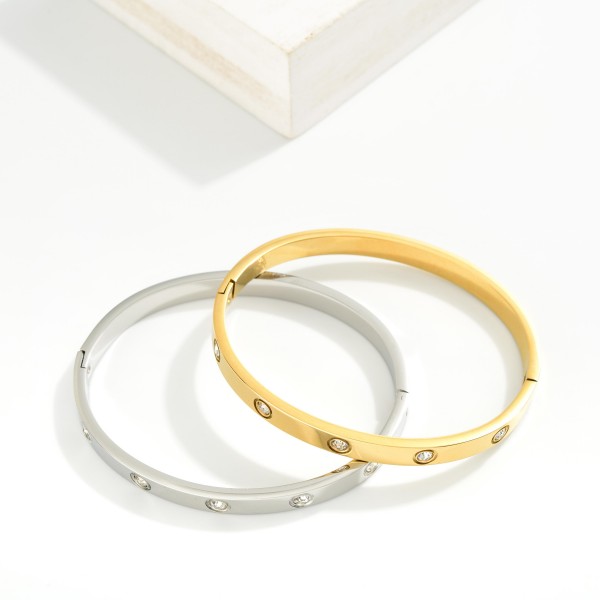Metal Tone Hinged Bangle Bracelet Featuring Rhinestone Details 

- Stainless Steel
- Water Resistant
- Approximately 2.5" D