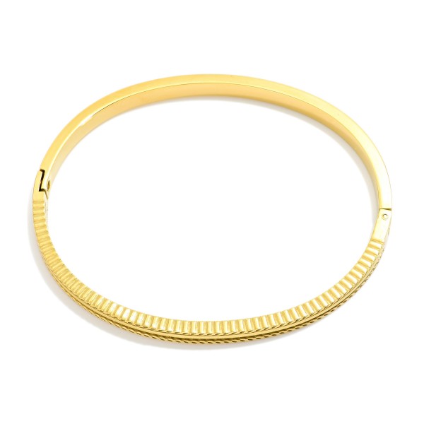 Metal Tone Hinged Bangle Bracelet Featuring Engraved Details 

- Stainless Steel
- Water Resistant
- Approximately 2.5" D