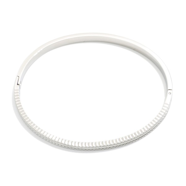 Metal Tone Hinged Bangle Bracelet Featuring Engraved Details 

- Stainless Steel
- Water Resistant
- Approximately 2.5" D