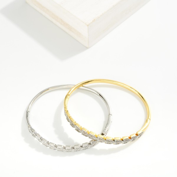 Metal Tone Hinged Bangle Bracelet Featuring Rhinestone V Details

- Stainless Steel
- Water Resistant
- Approximately 1.25" D