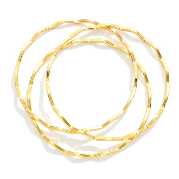 Set Of Three Gold Tone Zig-zag Metal Bangle Bracelet 

- Stainless Steel
- Water Resistant
- Approximately 2.75" D 