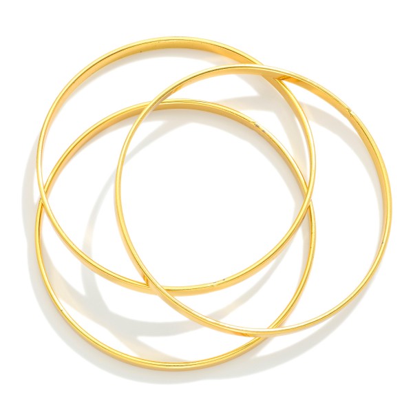 Set Of Three Gold Tone Flat Metal Bangle Bracelet 

- Approximately 2.75" D
- Stainless Steel
- Water Resistant
