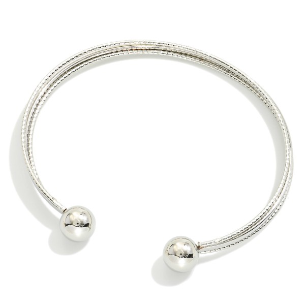 Metal Tone Cuff Bracelet With Ball Edges 

- Approximately 2.5" D