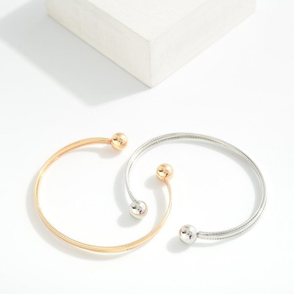 Metal Tone Cuff Bracelet With Ball Edges 

- Approximately 2.5" D