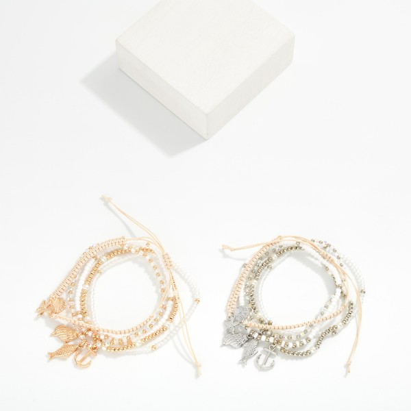 Set Of Five Beaded & Rope Bracelets Featuring Metal Tones, Seed Beads, & Beach Charms 

- Approximately 2.5" D