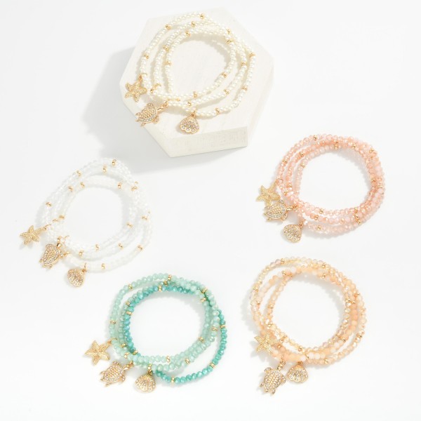 Set Of Three Pearl Bead Stretch Bracelets Featuring Metal Tones, & Beach Charms 

- Approximately  2.5" D 
