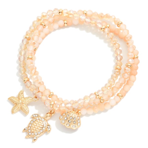 Set Of Three Faceted Bead Stretch Bracelets Featuring Metal Tones, & Beach Charms 

- Approximately  2.5" D 
