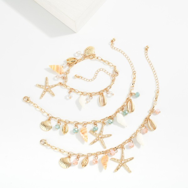 Chain Link Charm Bracelet Featuring Gold tones, Faceted Beads, & Beach Charms 

- Approximately 3" D
- Extender 2" L 