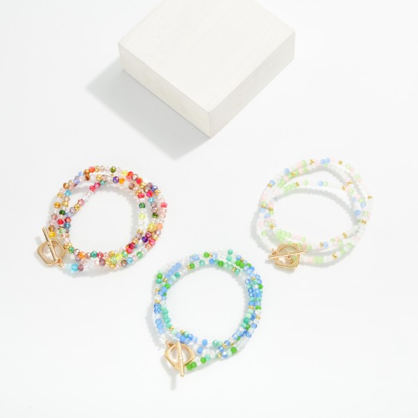 Set Of Three Faceted Bead Stretch Bracelets Featuring Gold Tones & Metal Toggle Clasp 

- Approximately 2.5" D 