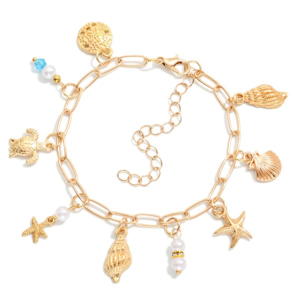 Paperclip Link Charm Bracelet Featuring Gold Tones, Pearls & Beach Charms 

- Approximately 3" D 
- Extender 2" L 