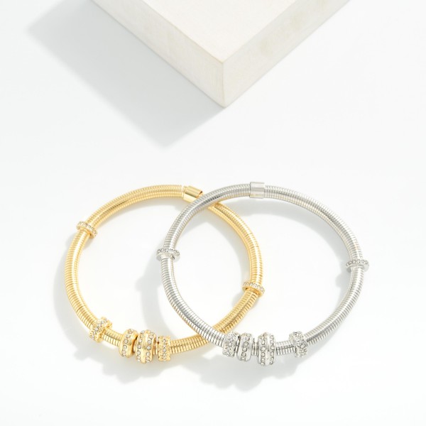 Metal Tone Coil Stretch Bracelet Featuring Rhinestone Bead Detail 

- Approximately 2.5" D