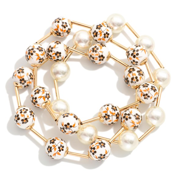 Set Of Three Beaded Stretch Bracelets Featuring Pearls, Metal Tone Tube, & Floral Porcelain Beads

- Approximately 3" D