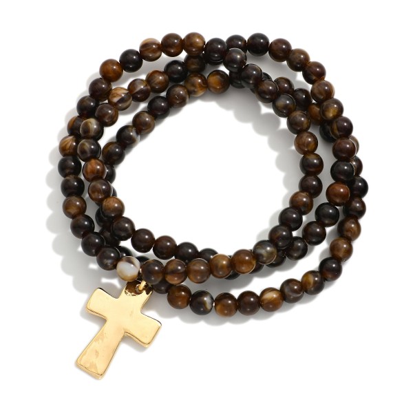 Set Of Three Beaded Stretch Bracelets Featuring Hammered Metal Cross Charm

- Approximately 2.5" D