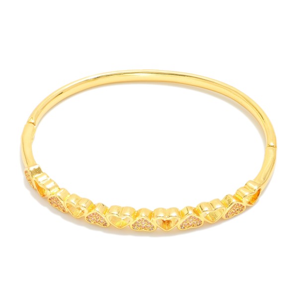 Metal Tone Heart Bangle Bracelet Featuring Cubic Zirconia Detail  

- Approximately 2.5" D 
- Gold Dipped
- Hypoallergenic  


