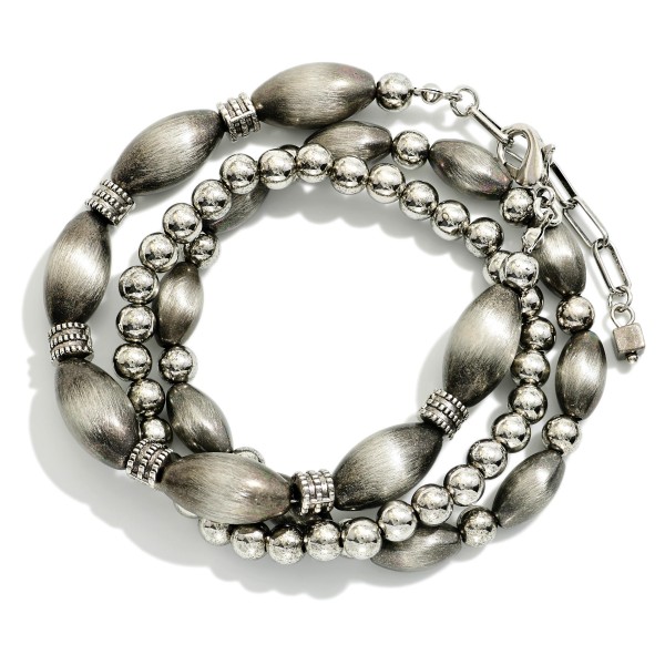 Set Of Three Metal Tone Brushed Beaded And Metal Tone Mixed Bead Stretch Bracelets 

- Approximately 2.5"  