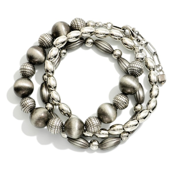 Set Of Three Metal Tone Brushed Beaded And Metal Tone Mixed Bead Stretch Bracelets 

- Approximately 2.5"  