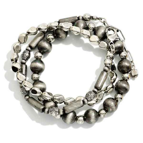 Set Of Three Metal Tone Brushed Beaded And Metal Tone Mixed Bead Stretch Bracelets 

- Approximately 2.5"  