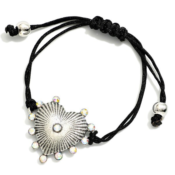 Adjustable Cord Bracelet Featuring Metal Tone Heart Charm & Rhinestone Accents 

- Approximately 3" D
