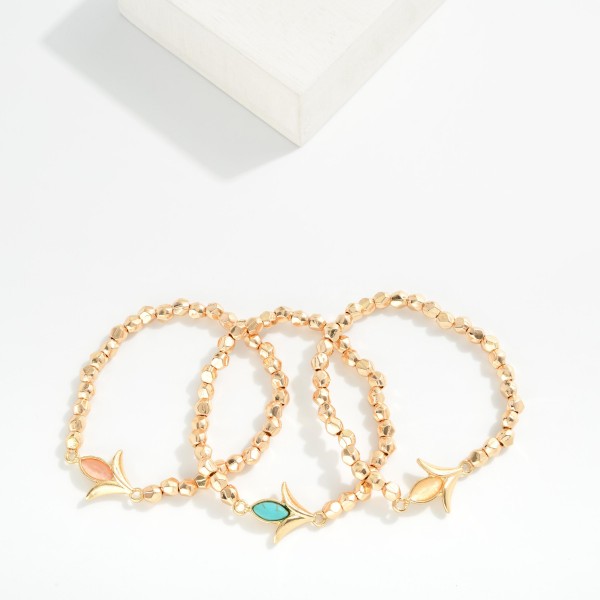 Metal Tone Beaded Stretch Bracelet Featuring Metal Tulip Shaped Charm 

- Approximately 2.5" D 