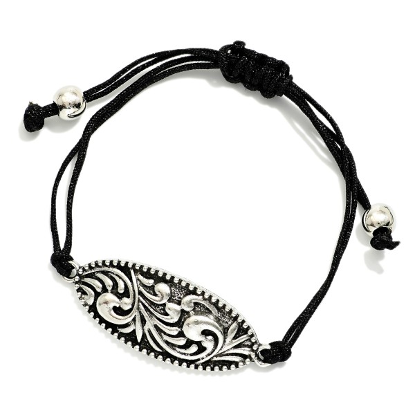 Adjustable Cord Bracelet Featuring Metal Tone Rococo Charm 

- Approximately 3" D
