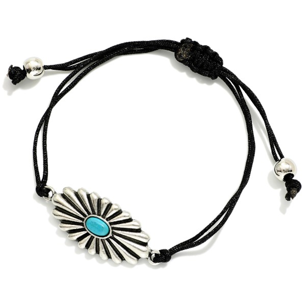 Adjustable Cord Bracelet Featuring Metal Tone Western Charm & Turquoise Accent

- Approximately 3" D
