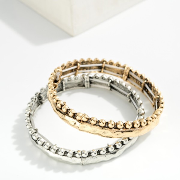 Metal Tone Hammered Bangle Stretch Bracelet Featuring Stud Ball Detail 

- Approximately 2.5" D 