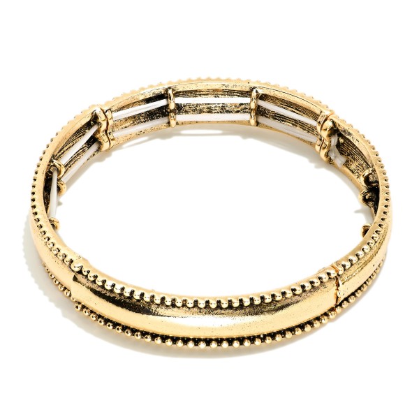 Metal Tone Bangle Stretch Bracelet Featuring Studded Edges 
 
- Approximately 2.5" D 