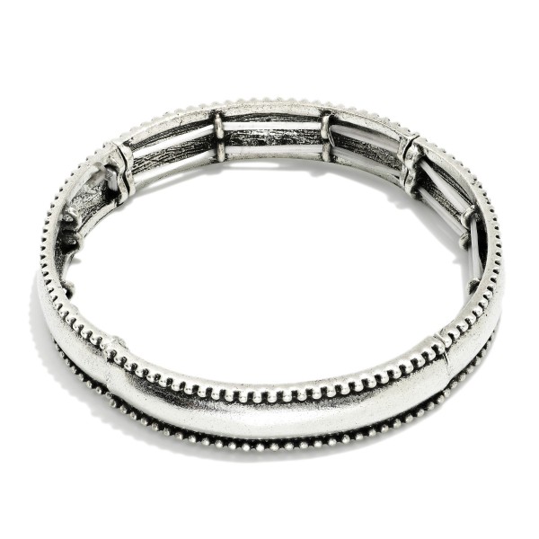 Metal Tone Bangle Stretch Bracelet Featuring Studded Edges 
 
- Approximately 2.5" D 