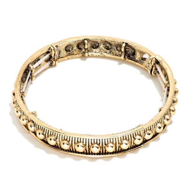 Metal Tone Bangle Stretch Bracelet Featuring Metal Tone Stud Accents 

- Approximately 2.5" D 