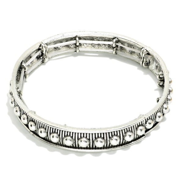 Metal Tone Bangle Stretch Bracelet Featuring Metal Tone Stud Accents 

- Approximately 2.5" D 