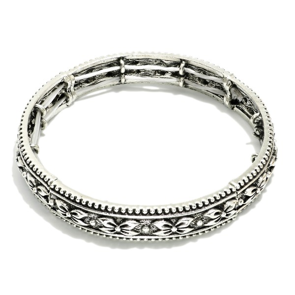 Metal Tone Bangle Stretch Bracelet Featuring Bow Engraving 

- Approximately 2.5" D 