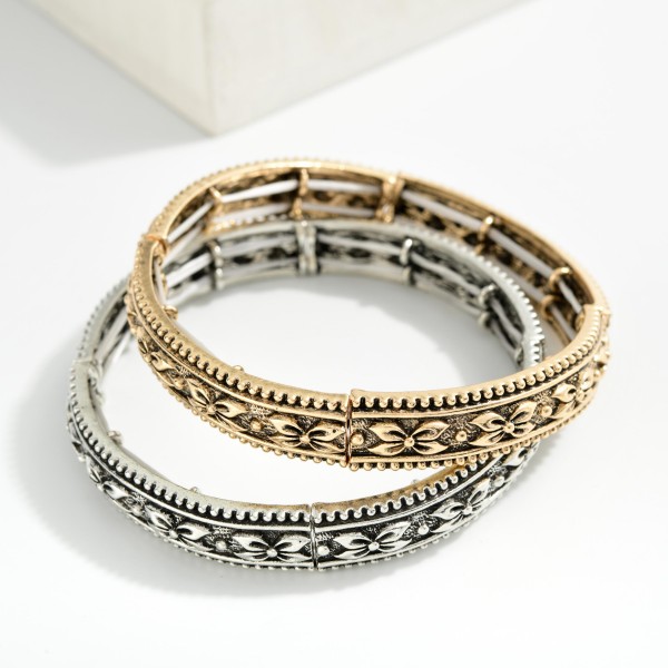 Metal Tone Bangle Stretch Bracelet Featuring Bow Engraving 

- Approximately 2.5" D 