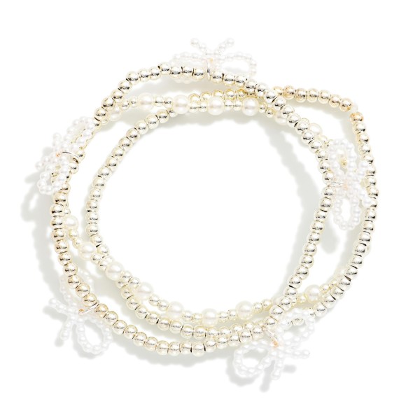Set Of Three Metal Tone & Pearl Beaded Stretch Bracelets With Bow Details 

- Approximately 2.5" D