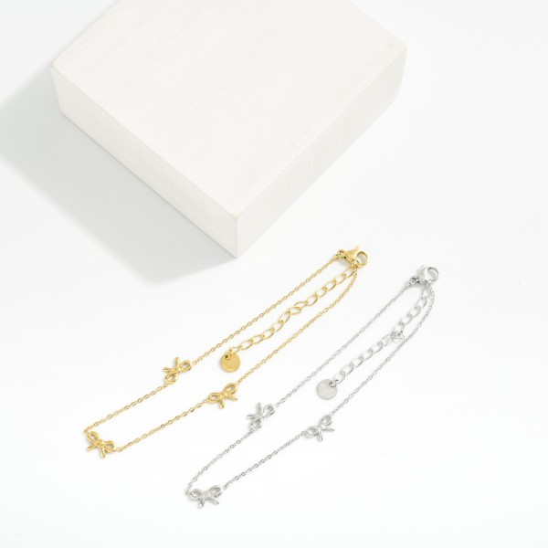 Metal Tone Chain Link Anklet Featuring Bow Stations 

- Approximately 3.05" D
- Stainless Steel
- Water & Tarnish Resistant 
- Hypoallergenic 