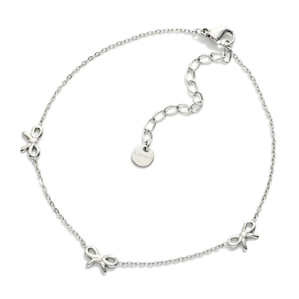 Metal Tone Chain Link Anklet Featuring Bow Stations 

- Approximately 3.05" D
- Stainless Steel
- Water & Tarnish Resistant 
- Hypoallergenic 