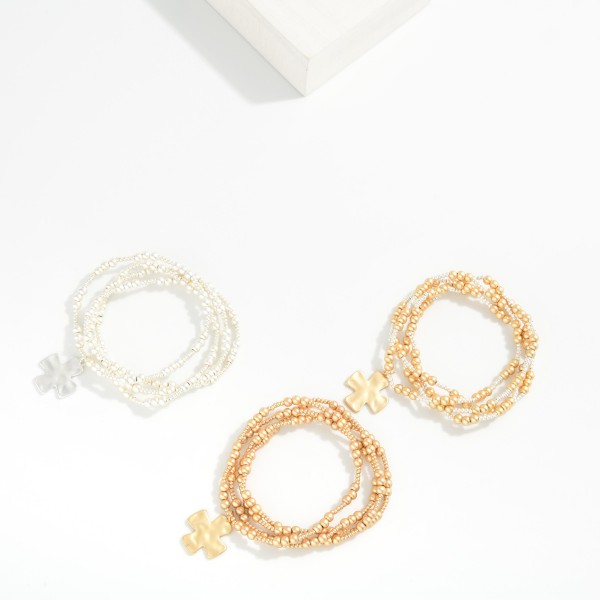 Set Of Four Metallic Beaded Stretch Bracelets Featuring Plus Cross Charm 

- Approximately 2.5" D 