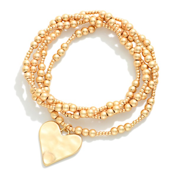 Set Of Four Metal Tone Beaded Stretch Bracelets Featuring Hammered Metal Heart Charm 

- Approximately 2.5" D
