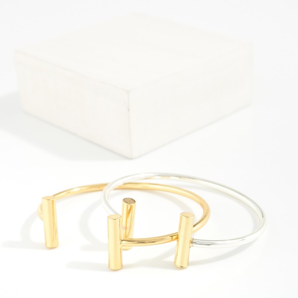 Metal Tone Cuff Bracelet With Metal Bar Edges 

- Approximately 2.5" D 