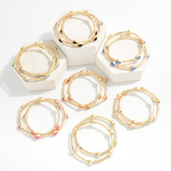 Set Of Two Hammered Metal Tone Bangle Bracelet Featuring Glitter Resin Oval Stations  

- Approximately 2.75