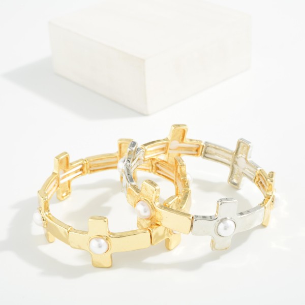 Metal Tone East West Cross Stretch Bracelet Featuring Pearls 

- Approximately 2.5" D 