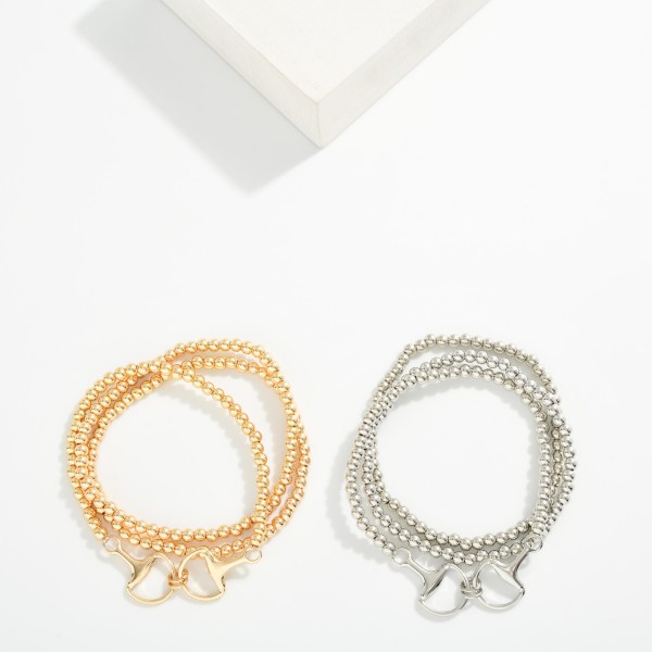 Set Of Three Metal Tone Beaded Stretch Bracelet Featuring Horsebit Charm 