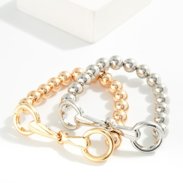 Metal Tone Beaded Stretch Bracelet Featuring Horsebit Detail 

- Approximately 2.75" D