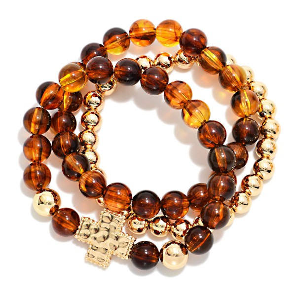 Set Of Three Beaded Stretch Bracelets Featuring Acetate Tortoise Beads, Metal Tones, & Plus Cross Station 

- Approximately 2.5" D