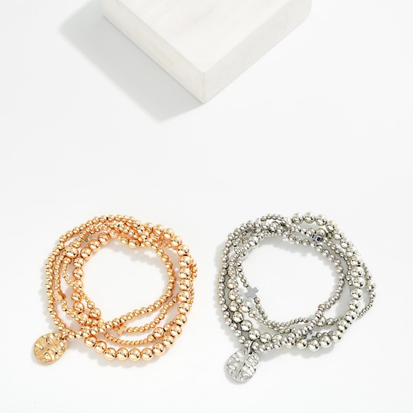 Set Of Four Metal Tone Beaded Stretch Bracelets Featuring Plus Crosses & Cross Charm

- Approximately 2.5" D 