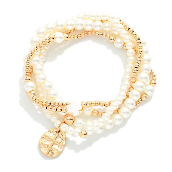 Set Of Four Metal Tone & Pearl Beaded Stretch Bracelets Featuring Hammered Metal Cross Medallion

- Approximately 2.5" D