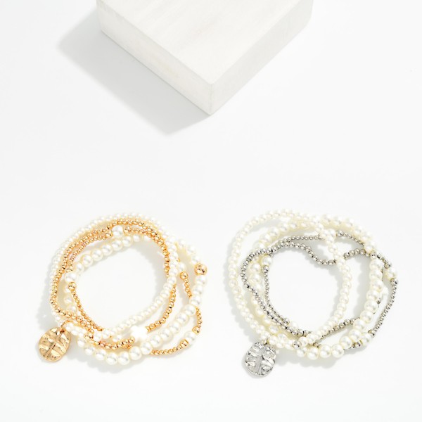 Set Of Four Metal Tone & Pearl Beaded Stretch Bracelets Featuring Hammered Metal Cross Medallion

- Approximately 2.5" D